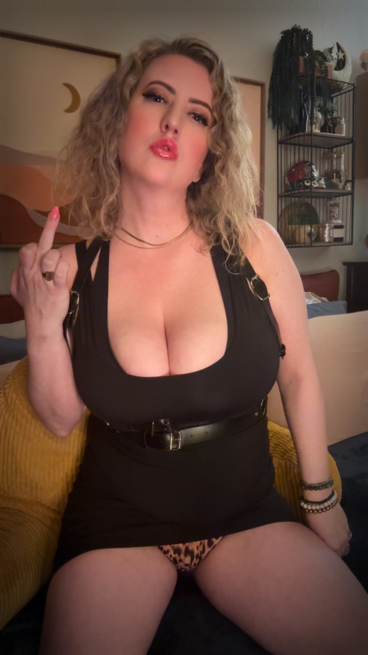 Flipping you off in tight black clothes and leopard panties.